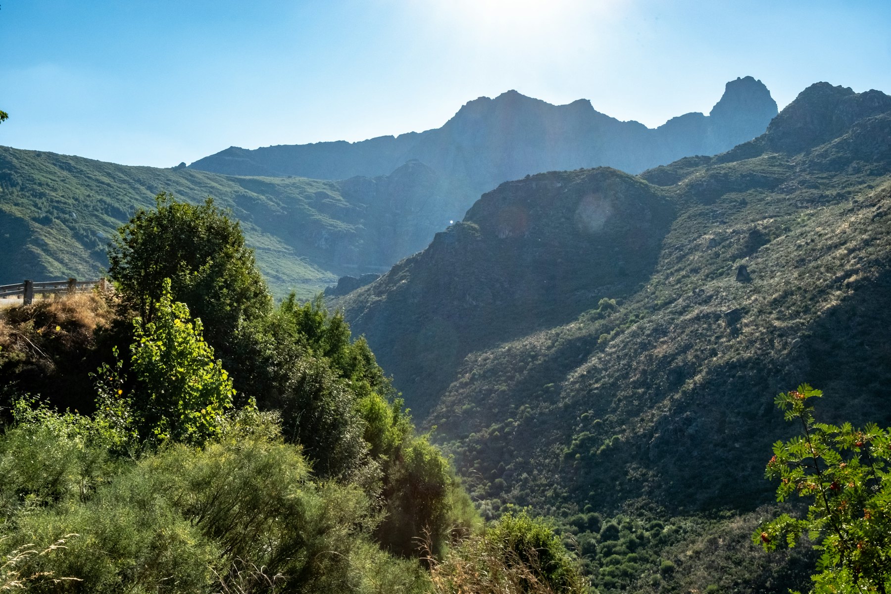 Green mountain valleys under a bright sky